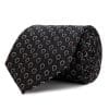 Plain black silk tie with embossed motifs.