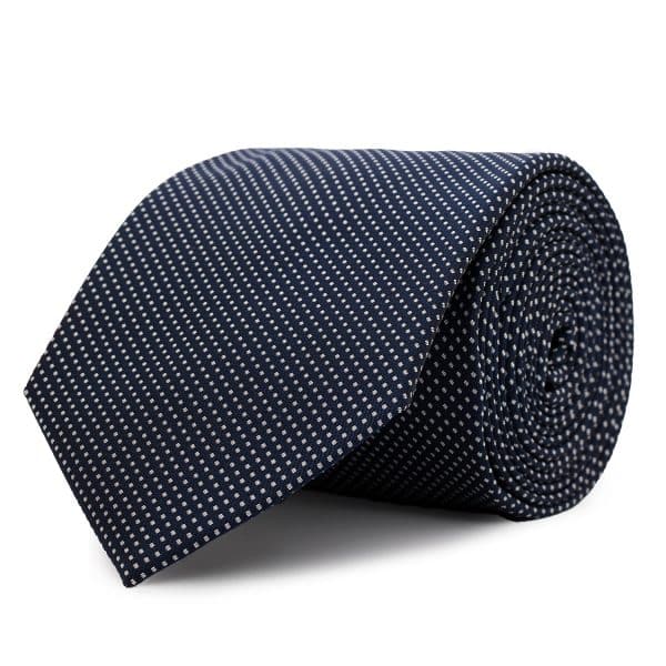 Spiked tie in Navy blue silk with small white polka dots.