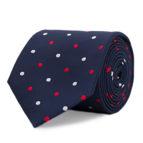 Silk tie with white and red polka dots on a navy blue background.